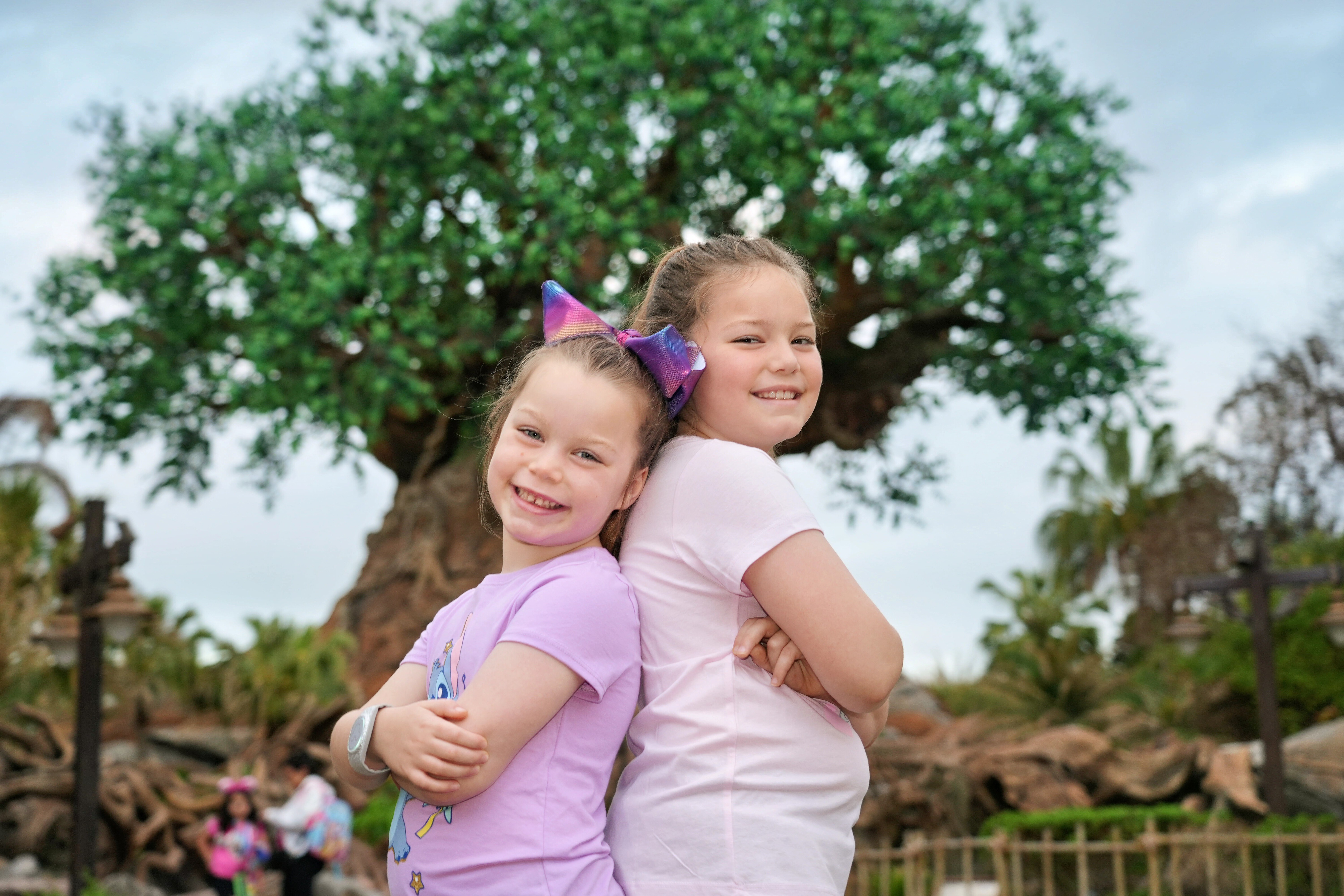 Zoey and Evie back to back at Animal Kingdom &mdash; both wearing bows